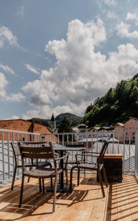 Terrasse eines Rooftop-Apartments von the salt mit Blick auf die Häuser in Hallein.